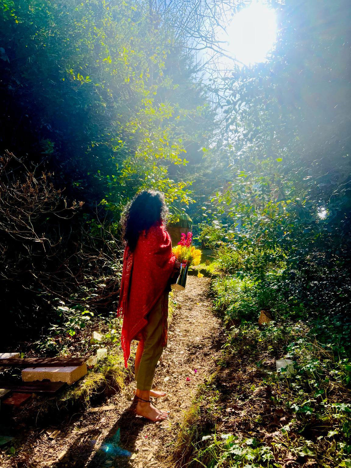 Sundeep walking a sunlit garden path